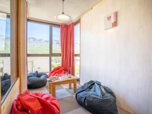 a room with two bean bags and a table with a window at Apartment Eskival 106 by Interhome in Val Thorens