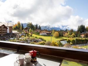 a table with a tea pot on a balcony with a view at Apartment Diamant 39 by Interhome in Villars-sur-Ollon +33 photos