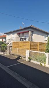 a house with a fence in front of it at Très grande maison individuelle in Aurillac