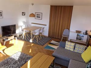 a living room with a couch and a table at Apartment Eden Roc 29 by Interhome in Vermala +34 photos