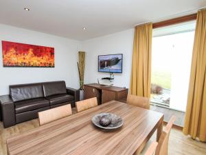 a living room with a table and a couch at Apartment Emma-3 by Interhome in Dürnberg