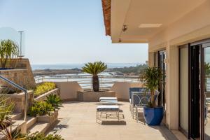a patio with chairs and plants on a balcony at Hotel Quinta do Lago in Quinta do Lago