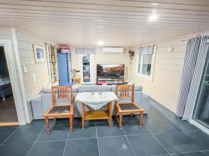 a room with a table and chairs and a couch at Holiday Home Villa blombacka by Interhome in Isnäs