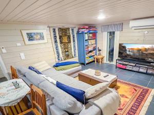 a living room with a couch and a table at Holiday Home Villa blombacka by Interhome in Isnäs