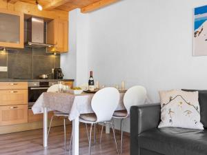 a kitchen and dining room with a table and chairs at Apartment Sundance 10-1 by Interhome in Les Crosets