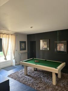 a room with a green pool table in it at Clos des Jacobins (Grand Cru Classé) in Saint-Émilion