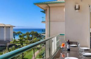 a balcony with a table and a view of the ocean at Honua Kai Resort And Spa By Maui Resort Rentals in Lahaina