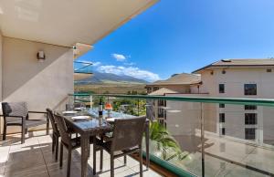a patio with a table and chairs on a balcony at Honua Kai Resort And Spa By Maui Resort Rentals in Lahaina