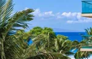 a view of the ocean from a building with palm trees at Honua Kai Resort And Spa By Maui Resort Rentals in Lahaina