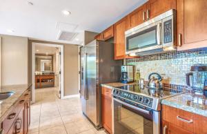 a kitchen with a stove and a microwave at Honua Kai Resort And Spa By Maui Resort Rentals in Lahaina