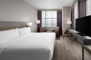 a hotel room with a bed and a television at AC Hotel by Marriott Orlando Downtown in Orlando