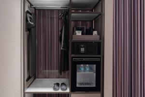 a room with a drink dispenser in a closet at AC Hotel by Marriott Orlando Downtown in Orlando