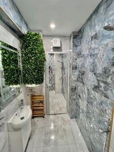 a bathroom with a toilet and a sink and a shower at Old Town Bamboo Tree 2 Bedroom in Vidin