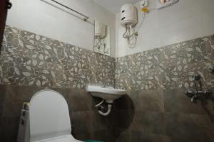 a bathroom with a toilet and a sink at Rural Vibes in Varkala