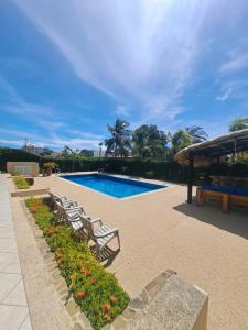 a swimming pool with lounge chairs in a resort at Yaque Suite in El Yaque