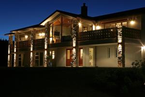 a house lit up at night with lights at Chalet Eiger in Taupo