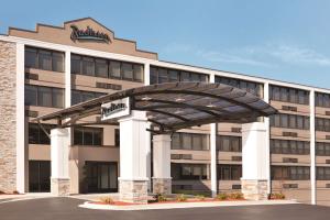 a large office building with a large arch in front of it at Radisson Hotel Charlotte Airport in Charlotte