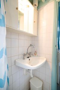 a bathroom with a sink and a toilet at Margarita's Houses in Astypalaia Town