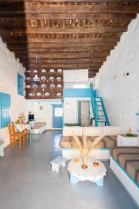 a living room with two beds and a table at Margarita's Houses in Astypalaia Town