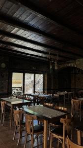 a dining room with tables and chairs and a building at Guesthouse Kastro in Edessa +30 photos