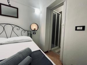 une chambre avec un lit et un miroir au mur dans l'établissement Casa Del Cuore- Wi-FI Free, à Dolceacqua