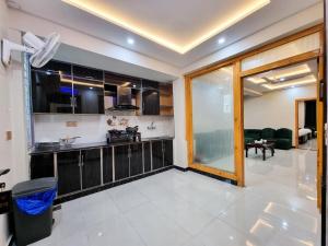 a kitchen and living room with a large window at Hotel Summer Palace Murree in Murree