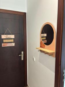 a mirror on a wall next to a door at Superbe appartement au centre de Cabo Negro en résidence avec piscines et tobogan in Cabo Negro