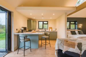 a bedroom with a bed and a kitchen with a counter at The Garden Room by Bloom Stays in Rye