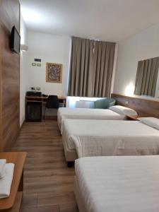 Postel nebo postele na pokoji v ubytování Hotel Tre Ville
