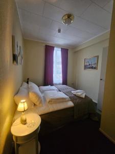 Postel nebo postele na pokoji v ubytování Eides Hotel