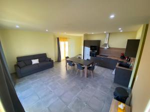 a living room with a couch and a table at T3 Gîte le Canigou in Trévillach