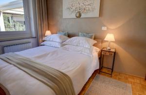 イゾラにあるApartma Bellavistaの白いシーツと枕が備わったベッドのある寝室