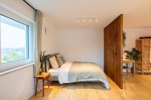 a bedroom with a bed and a large window at Design-Apartment in Langenbach bei München, nahe Flughafen München in Langenbach