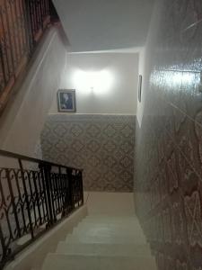 a stairway with a stair railing and a stair case at Maison d'hôtes afoulki tafraout in Tafraoute