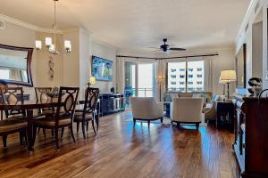 a dining room and living room with a table and chairs at Sandpearl Residences 606 in Clearwater Beach +57 photos