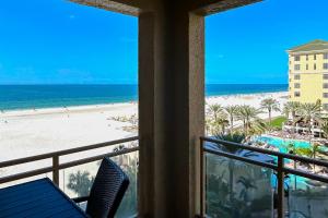a view of the beach from the balcony of a resort at Sandpearl Residences 606 in Clearwater Beach