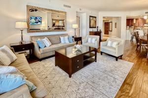 a living room with a couch and a table at Sandpearl Residences 606 in Clearwater Beach