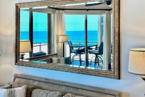 a mirror in a living room with a view of the ocean at Sandpearl Residences 606 in Clearwater Beach