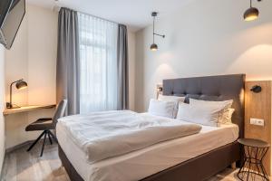 Postel nebo postele na pokoji v ubytování Hotel Esplanade Dortmund