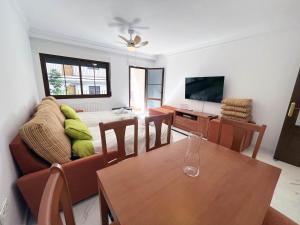 a living room with a table and a couch at Mshome Sierra Nevada Monachil in Monachil