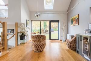 a living room with two chairs and a table at Woodside Lodge, surrounded by woodland and beautiful gardens in Wrington