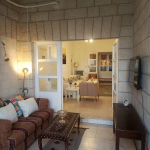 een woonkamer met een bank en een tafel bij B Beitna in Amman