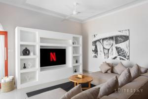 a living room with a couch and a tv at Two Bedroom Villa with Outdoor Pool in Umalas
