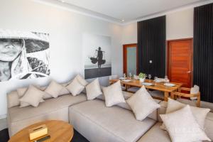 a living room with a couch and a table at Two Bedroom Villa with Outdoor Pool in Umalas