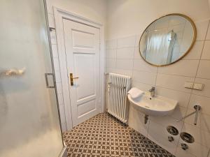 a bathroom with a sink and a mirror at Villa Kurfürst - 100 m zum Strand in Bansin +21 photos