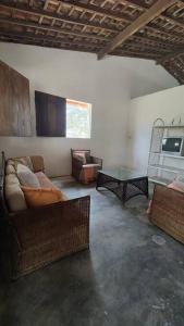 a living room with a couch and a table at Cabana Rústica de Fazenda in Sairé
