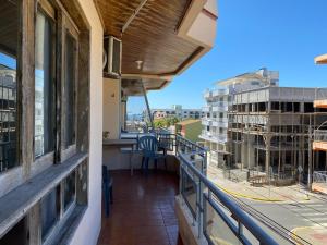 a balcony with a view of a building at Apto com Varanda 104 - Balneário Arroio do Silva - 300 metros do Mar in Arroio do Silva