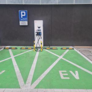 an atm machine in a parking lot next to a wall at Central Park Green Apartament in Wrocław