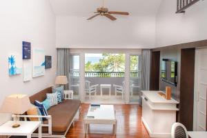 a living room with a couch and a table at Sheraton Samui Resort in Chaweng Noi Beach +37 photos
