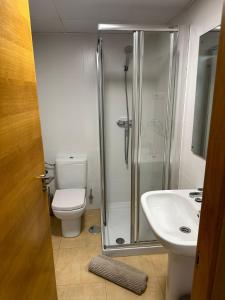 a bathroom with a shower and a toilet and a sink at Mar Menor Golf Resort 2 Bed Apartment in Los Martínez